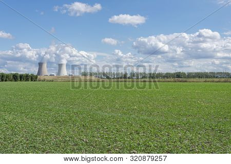 Landscape Photo Of The Nuclear Power Plant Of Doel In Belgium Right Next To A Row Of Trees And In Th