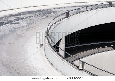 Drive-way Leading In Spirals To Subterranian Parking Garage In A City