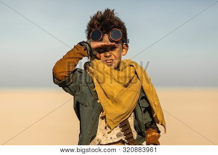 A Post Apocalyptic Boy Outdoors In Desert. Nuclear Post Apocalypse. Life After Doomsday Concept. Des