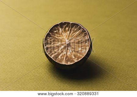The Concept Of Ugly Fruits And Citrus Fruits. Half Of The Sliced Lime Has Dried, Deteriorated And Is