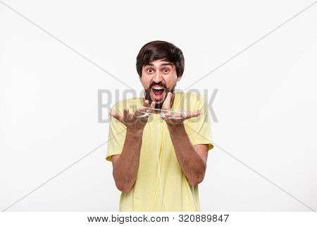 Pretty Brunet Bearded Man Gets Stressed Because His Wired Heardphones Got Tangled. Time To Get Wirel