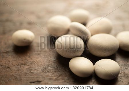 little white fluvial stones on wooden surface