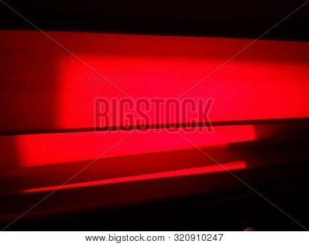 Close-up Of Dark Red Curtains In A Room. Fabric - Dense Velvet, With Daylight Entering The Back Of W