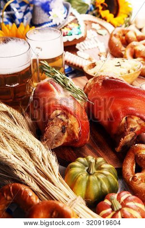 Traditional German Cuisine, Schweinshaxe Roasted Ham Hock. Beer, Pretzels And Various Bavarian Speci