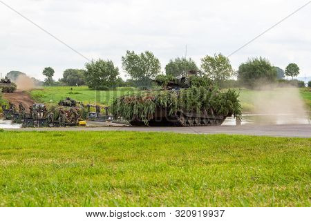 Minden / Germany - September 4, 2019: Panzerpionierbattaillon Trained A Tank Crossing Over A River W