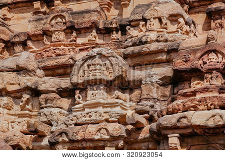 Textured Stone Wall Of Hindu Temple, India. Example Of 7th Century Indian Architecture With Reliefs 