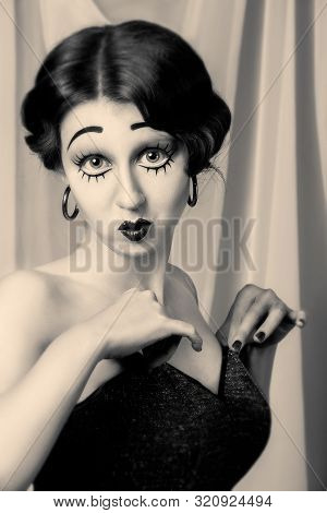 Fun Young Woman With Vintage Pinup Makeup Making Dolly Face Looking At Camera, Monochrome