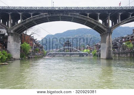 A Highway Overpass And Chinese Designed Bridge And Buildings Surround Both Sides Of The Tuo Jiang Ri