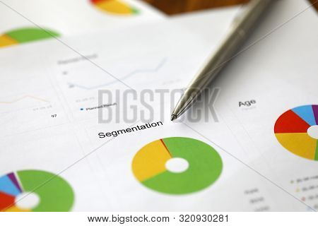 Pen Lie On The Paper Document With Busienss Strategy Chart Against Office Table Background. Slice Da