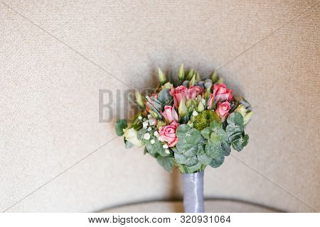 Wedding Bouquet Of Roses, Eustom And Eucalyptus On Beige . Copy Space