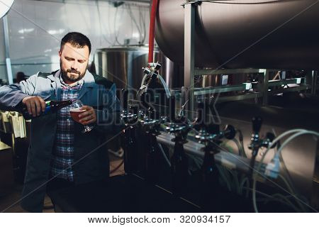 Portrait Of Brewer Who Is Making Beer On His Workplace In The Brew-house..