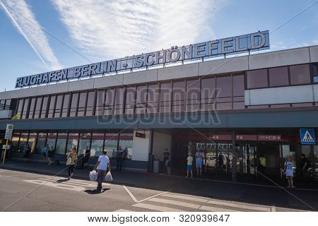 Berlin, Germany - July 2019: Facade Of Berlin Schonefeld Airport And Passengers In Berlin, Germany. 