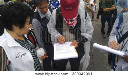 Seoul, South Korea; September 7, 2019: People Signing Petition During Demonstration Against South Ko