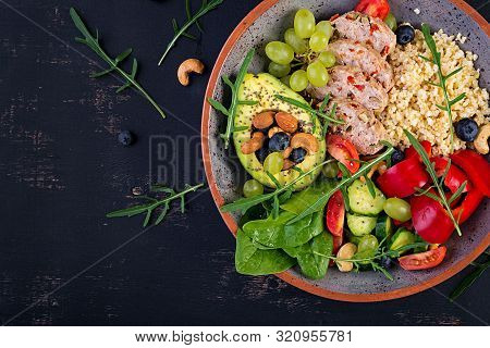 Buddha Bowl Dish With Meatloaf, Bulgur, Avocado, Sweet Pepper, Tomato, Cucumber, Berries And Nuts. D
