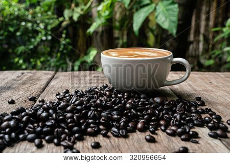 Latte Art Coffee In White Cup With Roast Bean