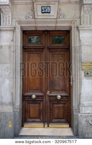 Paris / France - 06 26 2019: Old Wooden Door Under Vintage Number 239. Dark Wood Double Door Entranc
