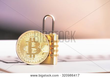 Bitcoin(btc) Coin With Padlock Lying On Computer Background. Bitcoin Security. Digital Cyber Safety 