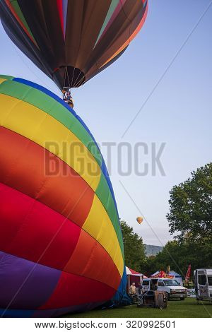 Festival Goers Watch Hot Air Balloons Take To Flight Early Saturday Morning, August 3, 2019 At The S