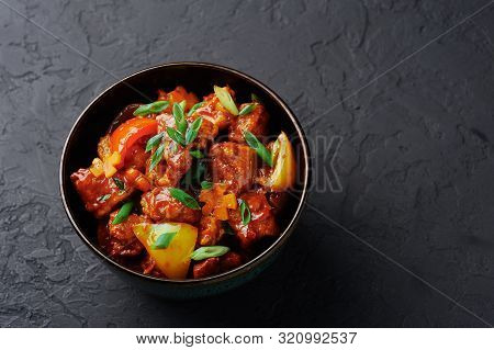 Chicken Manchurian In Pan At Black Concrete Background. Chicken Manchurian Is Indian Chinese Cuisine