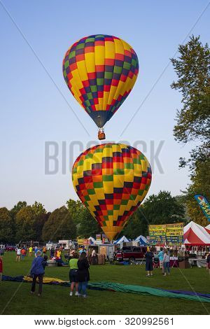 Festival Goers Watch Hot Air Balloons Take To Flight Early Saturday Morning, August 3, 2019 At The S