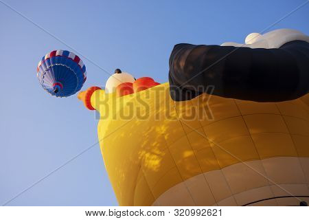 Festival Goers Watch Hot Air Balloons Take To Flight Early Saturday Morning, August 3, 2019 At The S