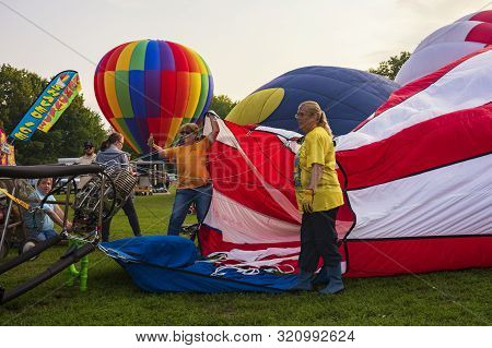 Festival Goers Watch Hot Air Balloons Take To Flight Early Saturday Morning, August 3, 2019 At The S