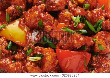 Chicken Manchurian In Pan At Black Concrete Background. Chicken Manchurian Is Indian Chinese Cuisine