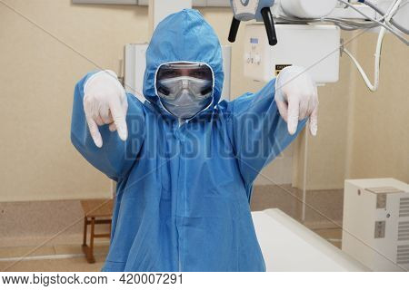 The Work Of A Radiologist In Antiviral Overalls In The X-ray Room For Diagnostics.