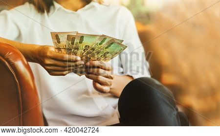 Femali Sat To Examine The Count Of The Five Thousand Thai Bank Notes In His Hand To Plan The Money F
