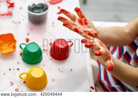 The Child Smeared His Hands In Kinetic Sand. An Educational Game Of Kinetic Sand With The Use Of Bri