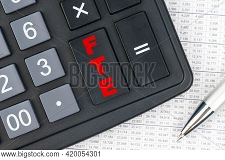 Business And Finance. On The Table Is A Report, A Pen And A Calculator, On The Big Key Of Which Is W