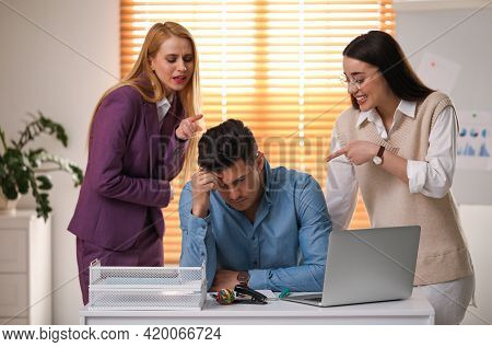 Coworkers Bullying Their Colleague At Workplace In Office