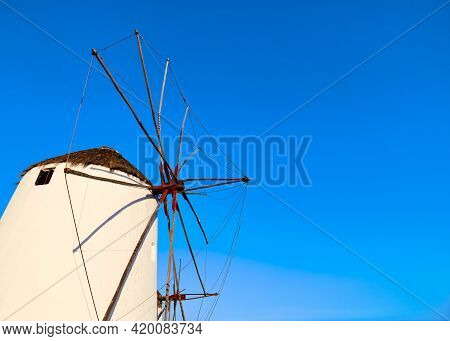 Famous Tourist Attraction Of Mykonos, Greece. Traditional Whitewashed Windmill At Clear Blue Sky. Su