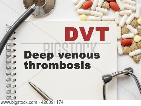 Page In Notebook With Dvt On White Background With Stethoscope And Group Of Pill. Medical Concept. T