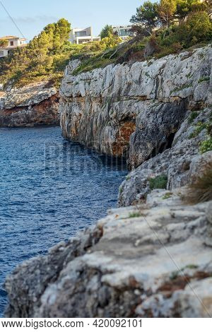 Rocky Seashore. Steep Coast. A Steep Cliff Near The Sea. Porto Cristo, Mallorca. Travel Concept. Hig