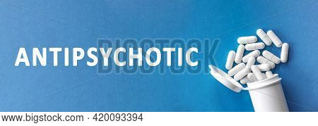 The Word Antipsychotic Is Written Near Pills On A Light Blue Background. Medical, Health And Happine