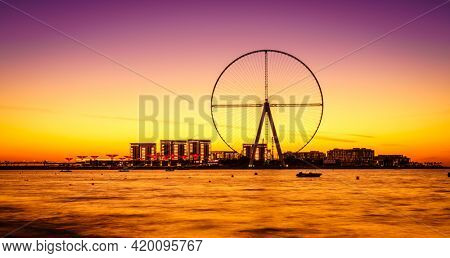 Twilight view of Bluewaters Island and Ain Dubai during construction, Dubai, UAE