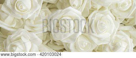 Banner With Background Of White Fake Flowers. Artificial White Foamirane Roses. Soft Focus