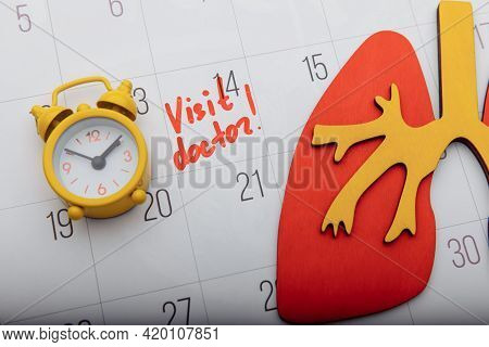 Model Of Lung On Calendar With Mark And Yellow Alarm Clock Close-up. Healthcare And Early Diagnostic