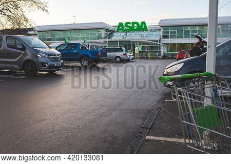 Swansea, Uk - January 3, 2021: Asda Supermarket Entrance, Car Park And Shopping Trolley