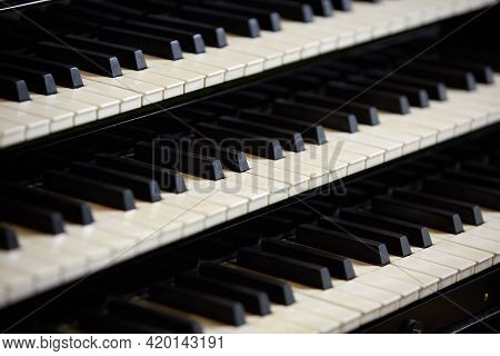 Simple Triple Pipe Organ Instrument Keyboard. Three Organ Keyboards Stack, Keys Closeup. 
Detail Of 