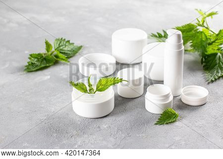 Natural Spa, Herbal Cosmetics With Nettle In White Bottles. Cosmetik Or Spa Concept, Copy Space