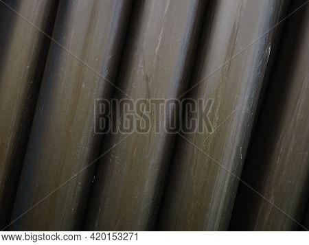 Irrigating With Hose Reel Irrigator. Rolled Up Of Black Rubber Hose, Industrial Detail.