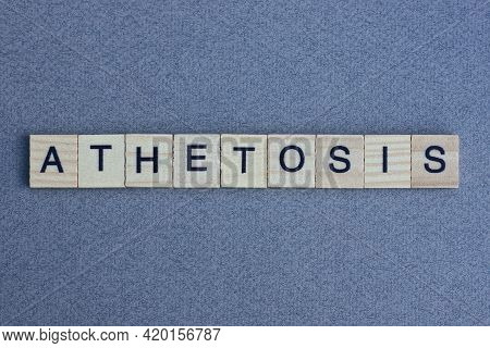 Text The Word Athetosis From Brown Wooden Small Letters With Black Font On An Gray Table