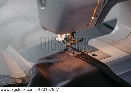 Sewing Machine, Close-up Of A Needle And Black Fabric. High Quality Photo