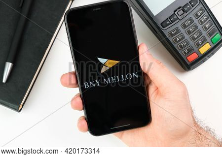 Bny Mellon Bank Logo On The Black Smartphone Screen In Mans Hand On The Background Of Payment Termin