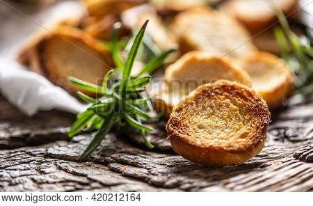 Crunchy And Savory Bake Rolly With Goldish Color Served In The Paper With Fresh Green Rosemary.