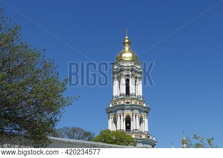 The Large Bell Tower Of The Kiev Pechersk Lavra Against The Blue Sky In Spring