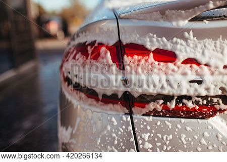 Taillight In Soapy Foam. Self-service Car Wash Concept