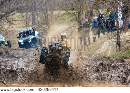 Afipsip, Russia - October 31, 2020: Sportsman On Quad Bike Drives Splashing In Dirt And Water At Mud